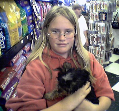 [Picture of Alyssa with a Yorkshire terrier puppy]